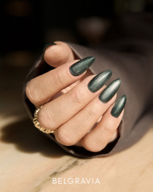 Dark-green cat-eye gel polish with silver magnetic shimmers