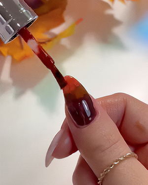 Applying brown gel polish for ombre nails