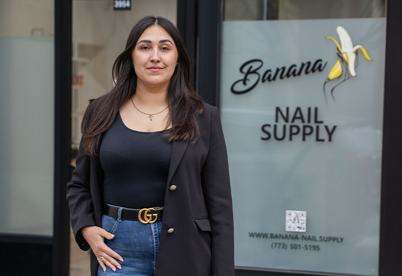 Salon owner and nail tech Anastasiia standing outside her nail supply store