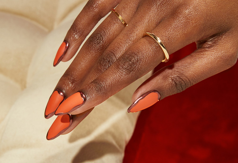 Orange nails with metallic chrome outlines